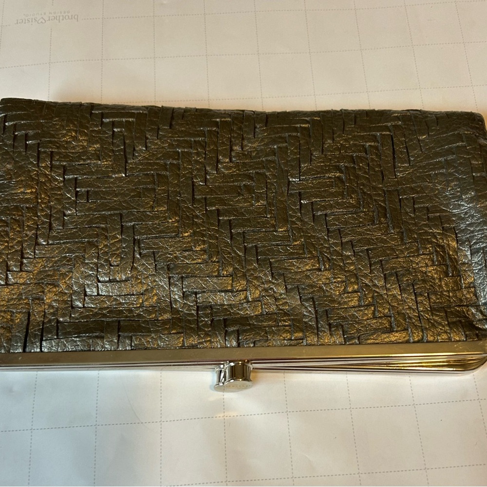 Evening clutch or handbag with a structured frame and double  clasp.